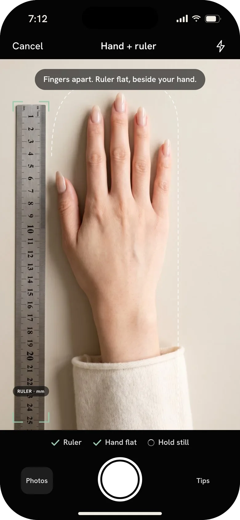 Mere app, Ring sizer: a hand lying flat beside a ruler in the camera view.